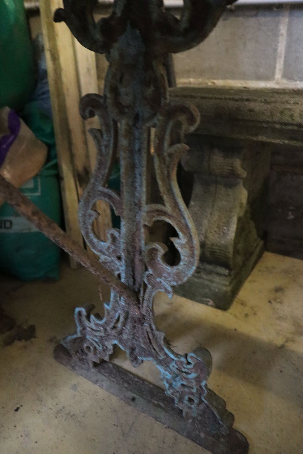 A Victorian painted cast iron slatted garden bench, width 126cm together with two cast iron marble top garden tables